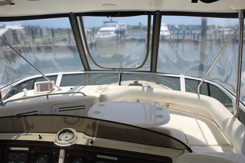 Slide: The Image of Interior view of 2000 Sea Ray 480 Sedan Bridge yacht cockpit with marina in background. - 16