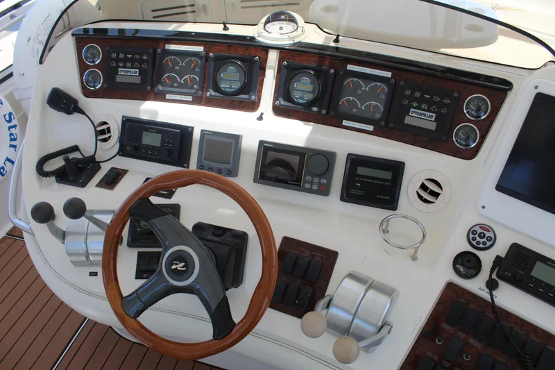 Slide: The Image of Control panel of a 2000 Sea Ray 480 Sedan Bridge yacht with wooden steering wheel. - 17