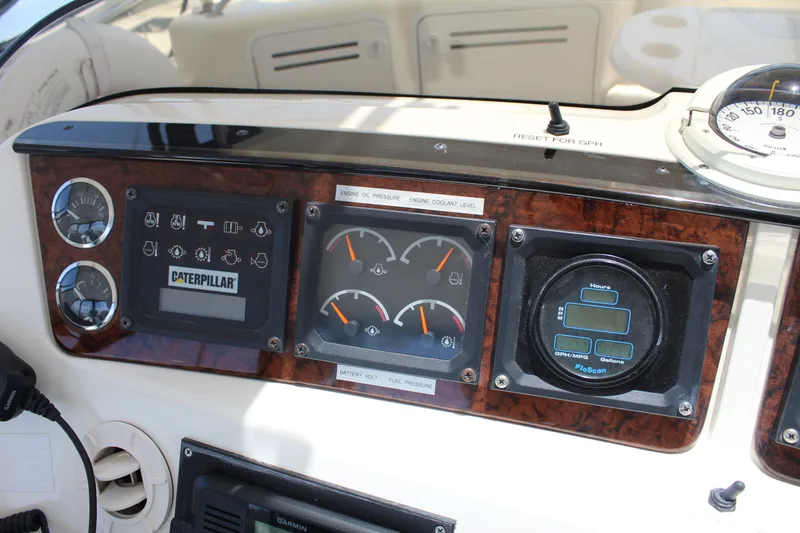 Slide: The Image of Control panel of 2000 Sea Ray 480 Sedan Bridge with gauges and Caterpillar display. - 18