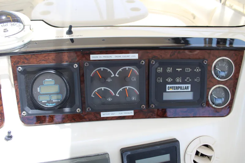 Slide: The Image of Control panel of a 2000 Sea Ray 480 Sedan Bridge with Caterpillar engine gauges. - 19