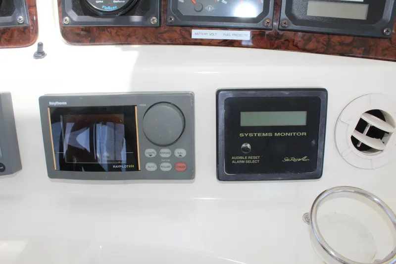 Slide: The Image of Control panel of a 2000 Sea Ray 480 Sedan Bridge with navigation and systems monitor. - 20