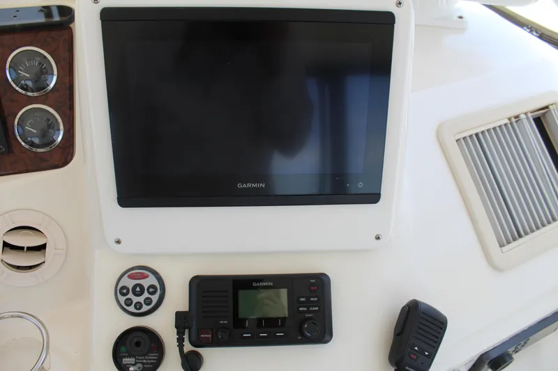 Slide: The Image of Control panel of 2000 Sea Ray 480 Sedan Bridge with Garmin display and radio equipment. - 23