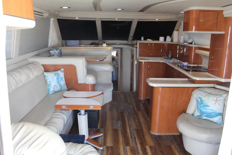 Slide: The Image of Interior of 2000 Sea Ray 480 Sedan Bridge yacht with elegant seating and wooden cabinetry. - 24