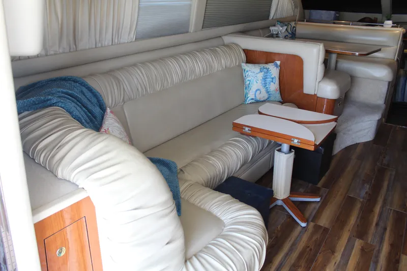 Slide: The Image of Luxurious interior of 2000 Sea Ray 480 Sedan Bridge with plush seating and wooden accents. - 25