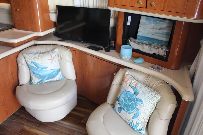 Slide: The Image of Luxurious interior of 2000 Sea Ray 480 Sedan Bridge with plush seating and marine-themed decor. - 26