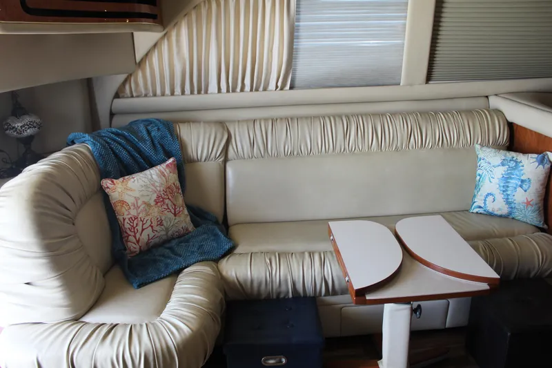 Slide: The Image of Interior of 2000 Sea Ray 480 Sedan Bridge with beige seating and decorative pillows. - 27