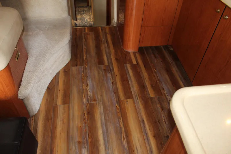 Slide: The Image of Interior of 2000 Sea Ray 480 Sedan Bridge with wood flooring and cabinetry. - 31