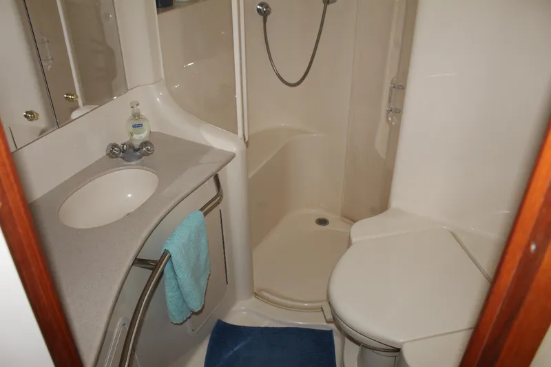 Slide: The Image of Bathroom interior of 2000 Sea Ray 480 Sedan Bridge yacht, featuring sink, shower, and toilet. - 33