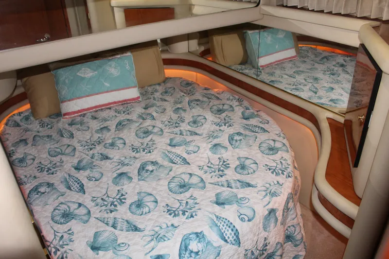 Slide: The Image of Luxurious bedroom interior of 2000 Sea Ray 480 Sedan Bridge yacht with seashell-themed bedding. - 35