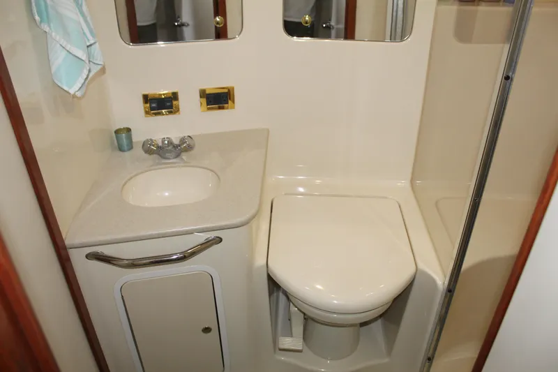 Slide: The Image of Bathroom interior of 2000 Sea Ray 480 Sedan Bridge yacht, featuring sink and toilet. - 38