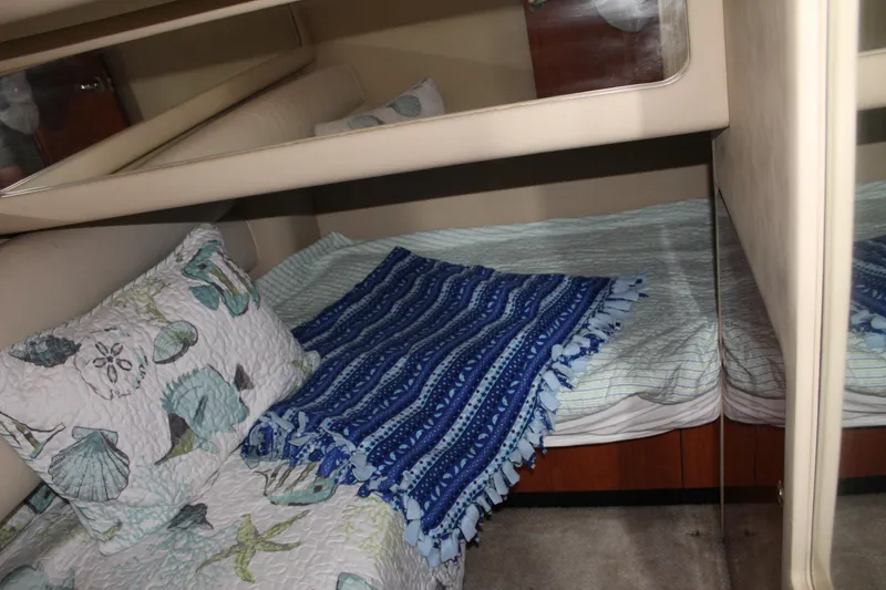 Slide: The Image of 2000 Sea Ray 480 Sedan Bridge cabin with cozy bedding and decorative pillows. - 41