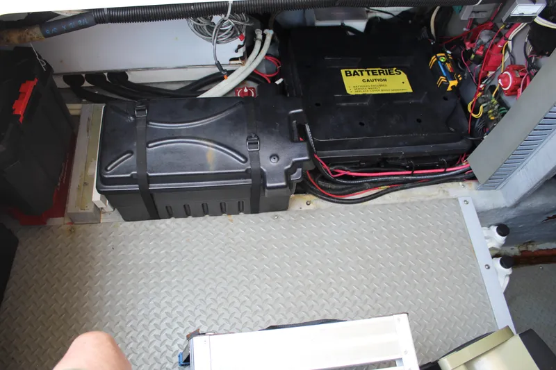 Slide: The Image of Battery compartment of a 2000 Sea Ray 480 Sedan Bridge with wiring and caution label. - 42
