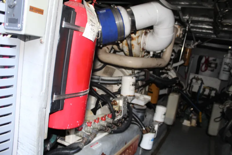 Slide: The Image of Engine room of a 2000 Sea Ray 480 Sedan Bridge with visible fire extinguisher. - 45