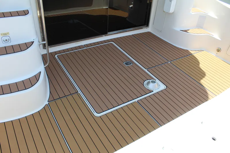 Slide: The Image of 2000 Sea Ray 480 Sedan Bridge deck with teak flooring and access hatch. - 6