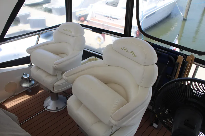 Slide: The Image of Luxurious Sea Ray 480 Sedan Bridge helm chairs, 2000 model, with marina view. - 9