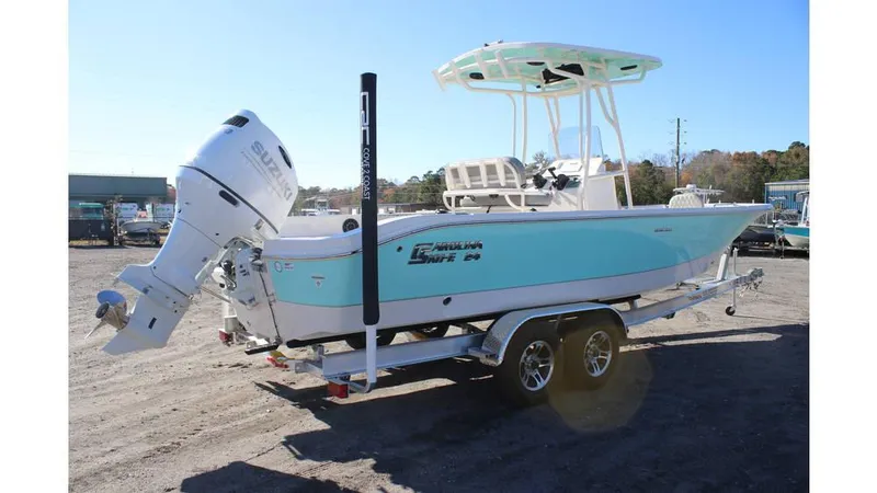 Slide: The Image of 2025 Carolina Skiff 24 Ultra Elite boat on trailer, featuring outboard motor. - 1