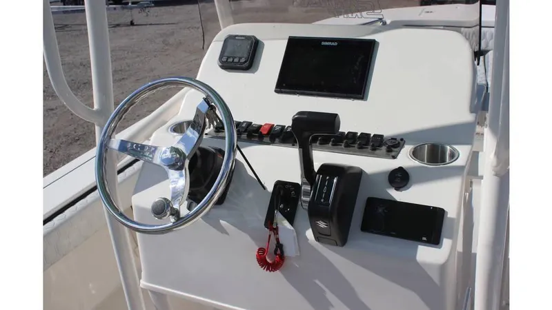 Slide: The Image of 2025 Carolina Skiff 24 Ultra Elite boat console with steering wheel and controls. - 10