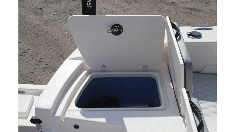 Slide: The Image of 2025 Carolina Skiff 24 Ultra Elite boat storage compartment open, showcasing interior space. - 13
