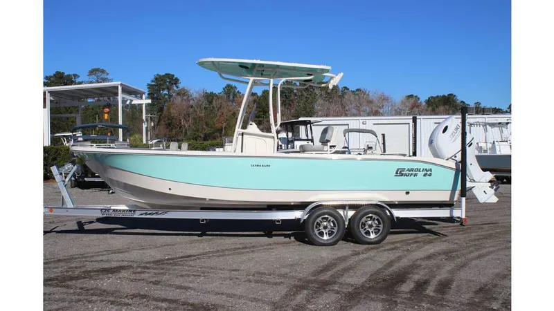 Slide: The Image of 2025 Carolina Skiff 24 Ultra Elite boat on trailer, side view, outdoors. - 2