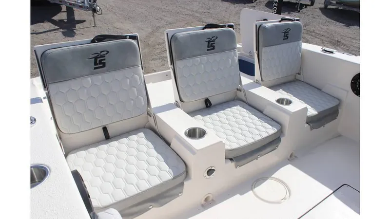 Slide: The Image of 2025 Carolina Skiff 24 Ultra Elite boat seats with cup holders, featuring stylish gray upholstery. - 5
