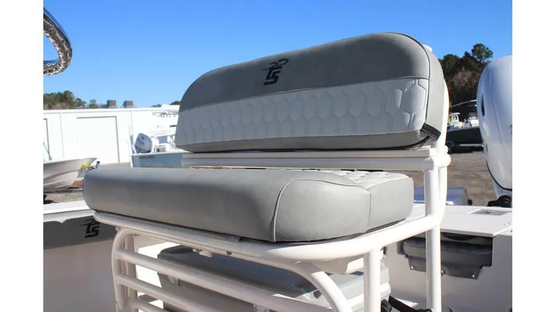 Slide: The Image of 2025 Carolina Skiff 24 Ultra Elite boat seat, gray upholstery, outdoor setting. - 6