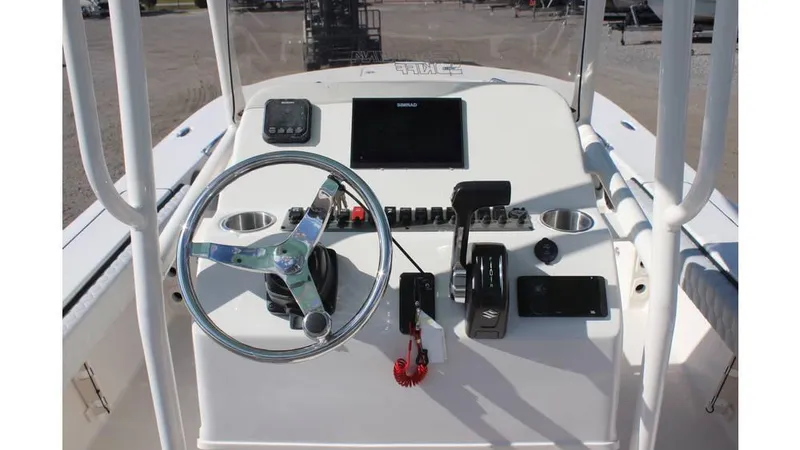 Slide: The Image of 2025 Carolina Skiff 24 Ultra Elite boat dashboard with steering wheel and controls. - 9