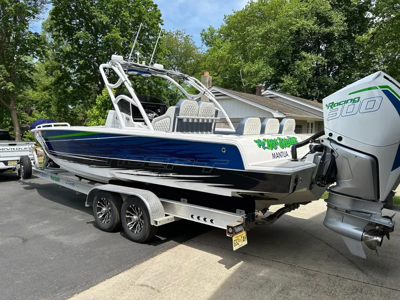 Slide: The Image of 2021 Concept 30 Open boat on trailer, featuring Racing 300 engine, parked outdoors. - 0