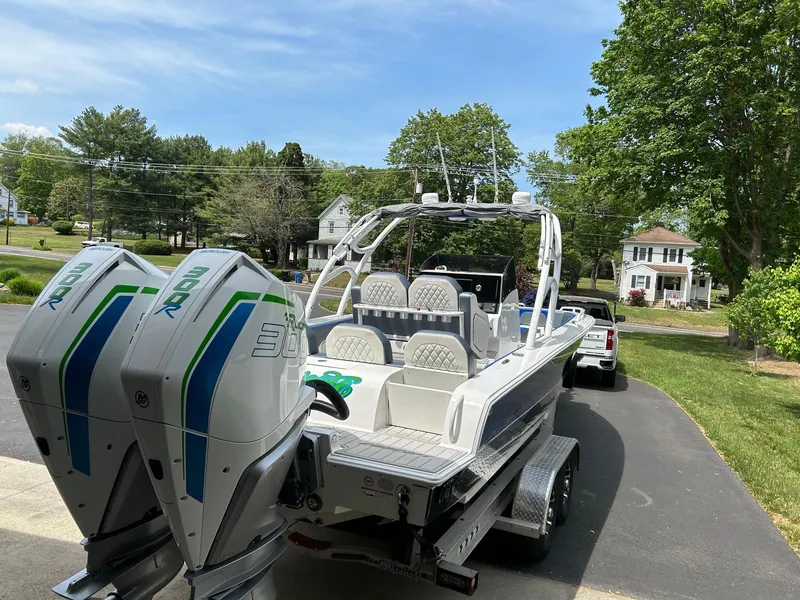 Slide: The Image of 2021 Concept 30 Open boat with dual 300R engines on a driveway. - 5