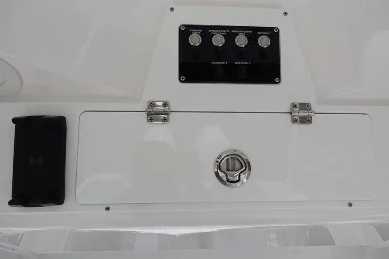 Slide: The Image of 2024 Sea Fox 268 Commander control panel with switches and storage compartment. - 15