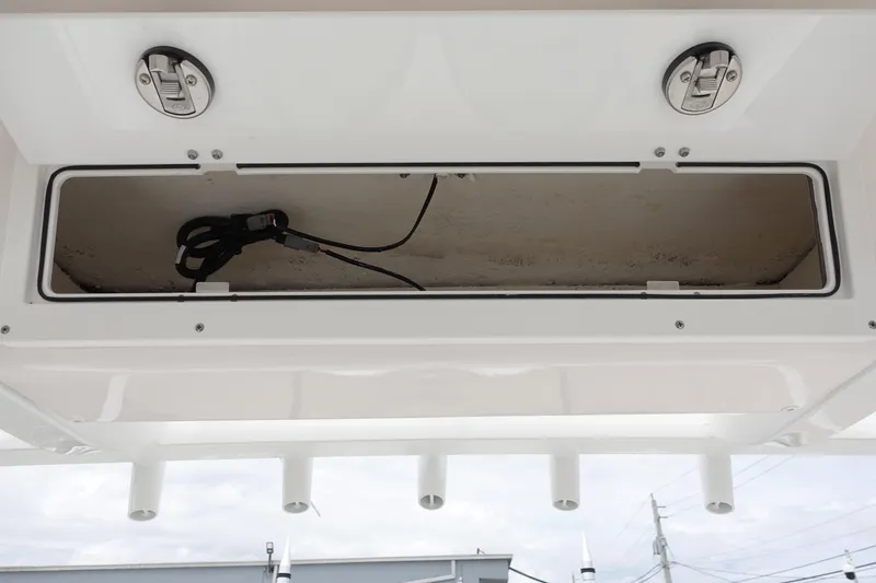 Slide: The Image of 2024 Sea Fox 268 Commander storage compartment with rod holders and secure latches. - 16