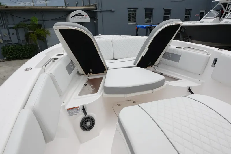 Slide: The Image of 2024 Sea Fox 268 Commander boat interior with white cushioned seating and storage compartments. - 22