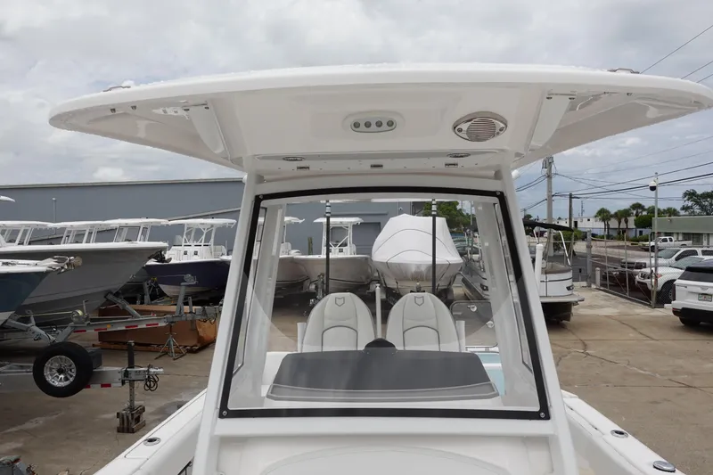 Slide: The Image of 2024 Sea Fox 268 Commander boat with T-top, docked in a marina. - 25