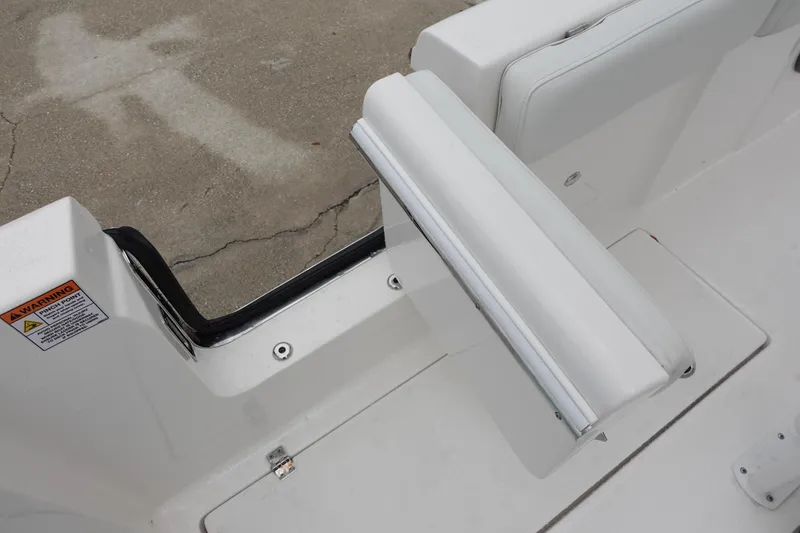 Slide: The Image of 2024 Sea Fox 268 Commander boat interior with white seating and storage area. - 26