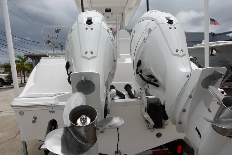 Slide: The Image of 2024 Sea Fox 268 Commander with dual outboard engines, docked under cloudy skies. - 33