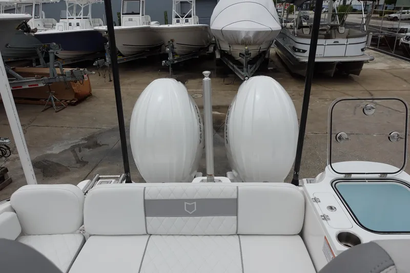 Slide: The Image of 2024 Sea Fox 268 Commander boat with dual engines, docked among other boats. - 8