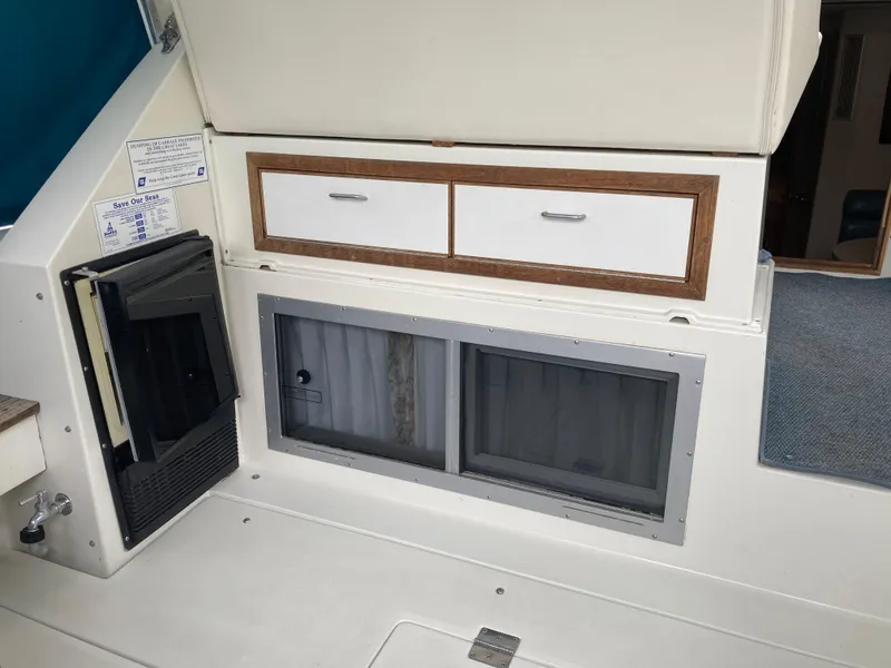 Slide: The Image of 1988 Carver 3257 Montego interior with storage drawers and window. - 11