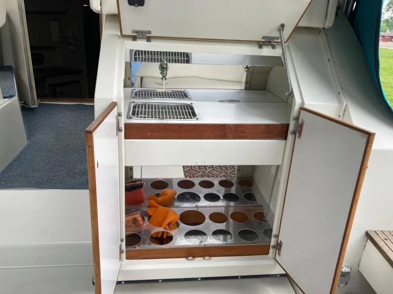 Slide: The Image of 1988 Carver 3257 MONTEGO boat kitchenette with sink and storage compartments. - 13