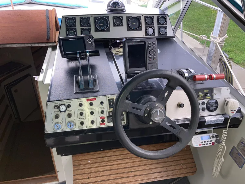 Slide: The Image of 1988 Carver 3257 MONTEGO boat dashboard with steering wheel and navigation instruments. - 14
