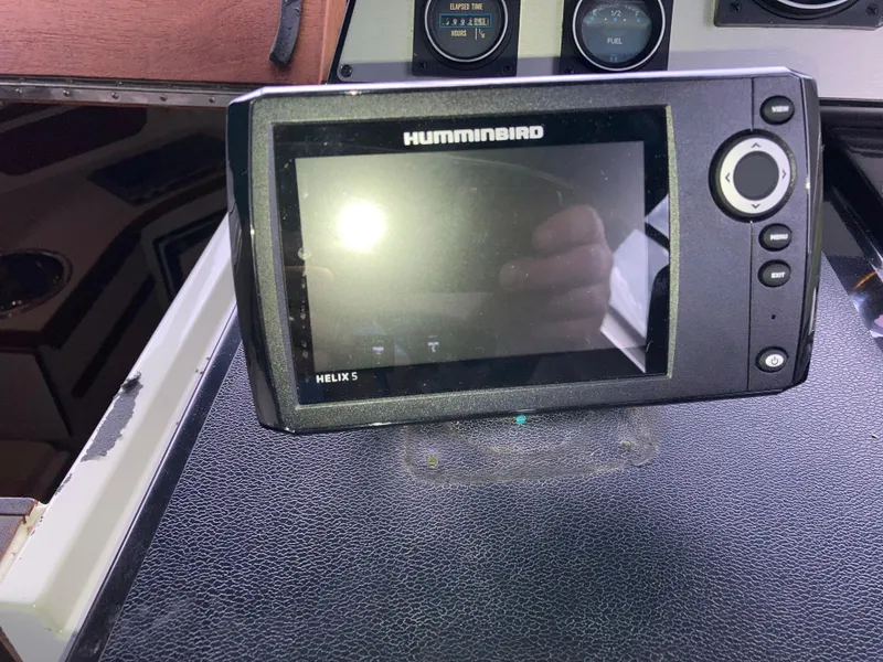 Slide: The Image of Humminbird Helix 5 fish finder on 1988 Carver 3257 Montego dashboard. - 15