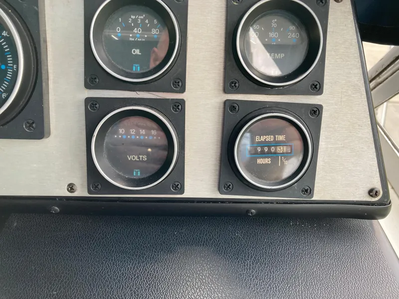 Slide: The Image of Dashboard gauges of a 1988 Carver 3257 MONTEGO boat, displaying oil, temperature, volts, and elapsed time. - 17