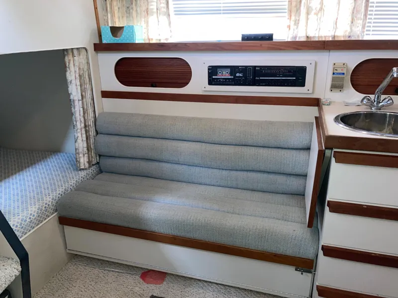 Slide: The Image of 1988 Carver 3257 Montego interior with cushioned seating, sink, and control panel. - 19