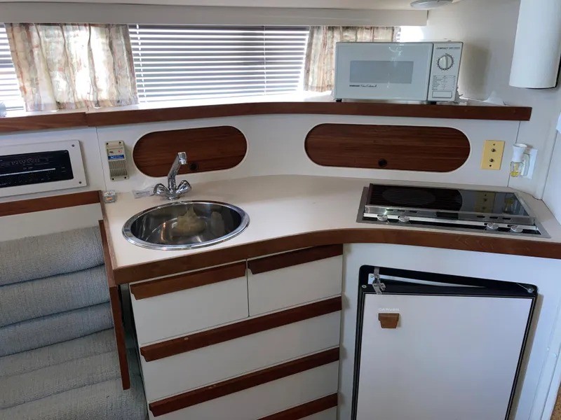 Slide: The Image of Compact kitchen in 1988 Carver 3257 MONTEGO boat with sink, stove, and microwave. - 20
