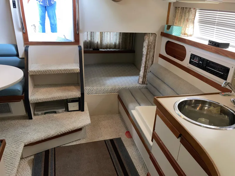 Slide: The Image of Interior of 1988 Carver 3257 MONTEGO boat with seating, sink, and stairs. - 25