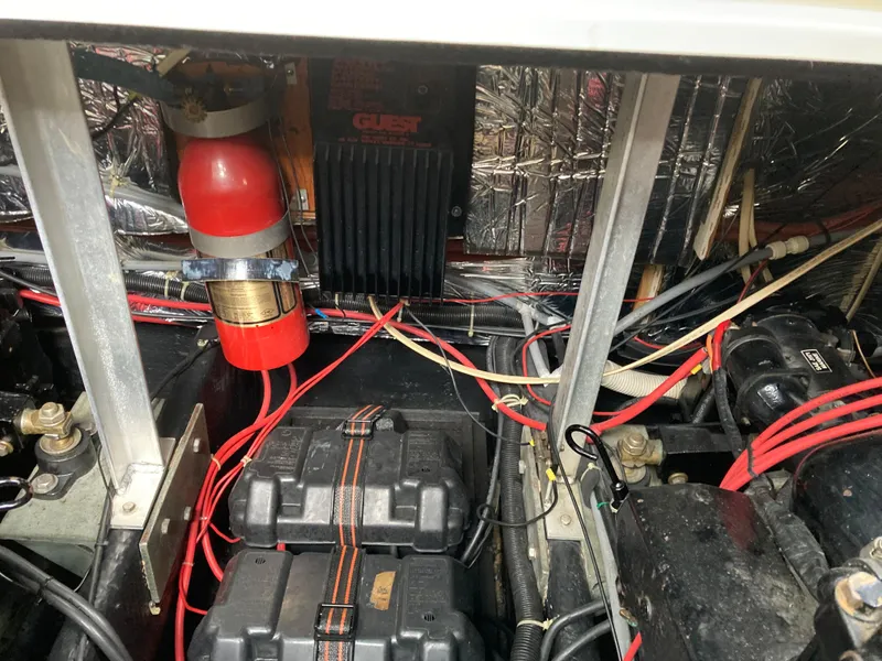 Slide: The Image of Engine compartment of 1988 Carver 3257 MONTEGO with wiring and battery setup. - 28