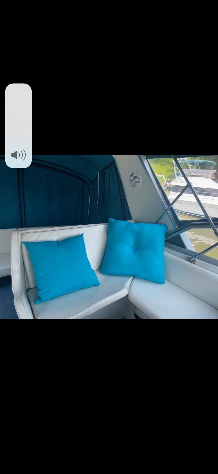 Slide: The Image of Interior of 1988 Carver 3257 MONTEGO with blue cushions and white seating. - 3