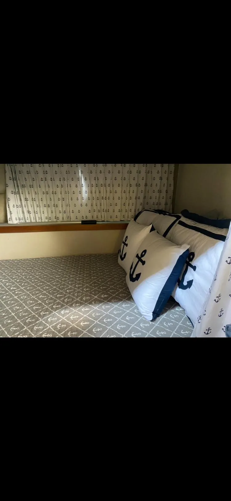 Slide: The Image of Nautical-themed bedding in 1988 Carver 3257 MONTEGO cabin with anchor pillows and patterned sheets. - 5