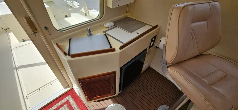 Slide: The Image of Interior of 2001 Rosborough RF-246 Custom Wheelhouse with seating and compact kitchenette. - 11