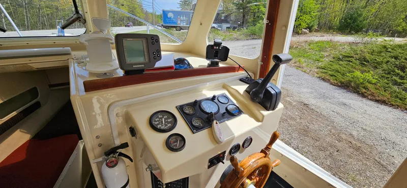 Slide: The Image of 2001 Rosborough RF-246 Custom Wheelhouse interior with navigation instruments and steering wheel. - 14
