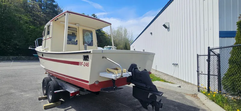 Slide: The Image of 2001 Rosborough RF-246 Custom Wheelhouse boat on trailer, parked near a building. - 18