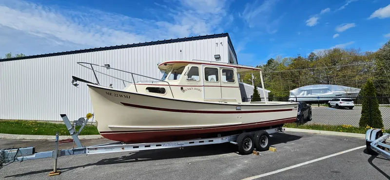 Slide: The Image of 2001 Rosborough RF-246 Custom Wheelhouse boat on trailer, parked outdoors under blue sky. - 19